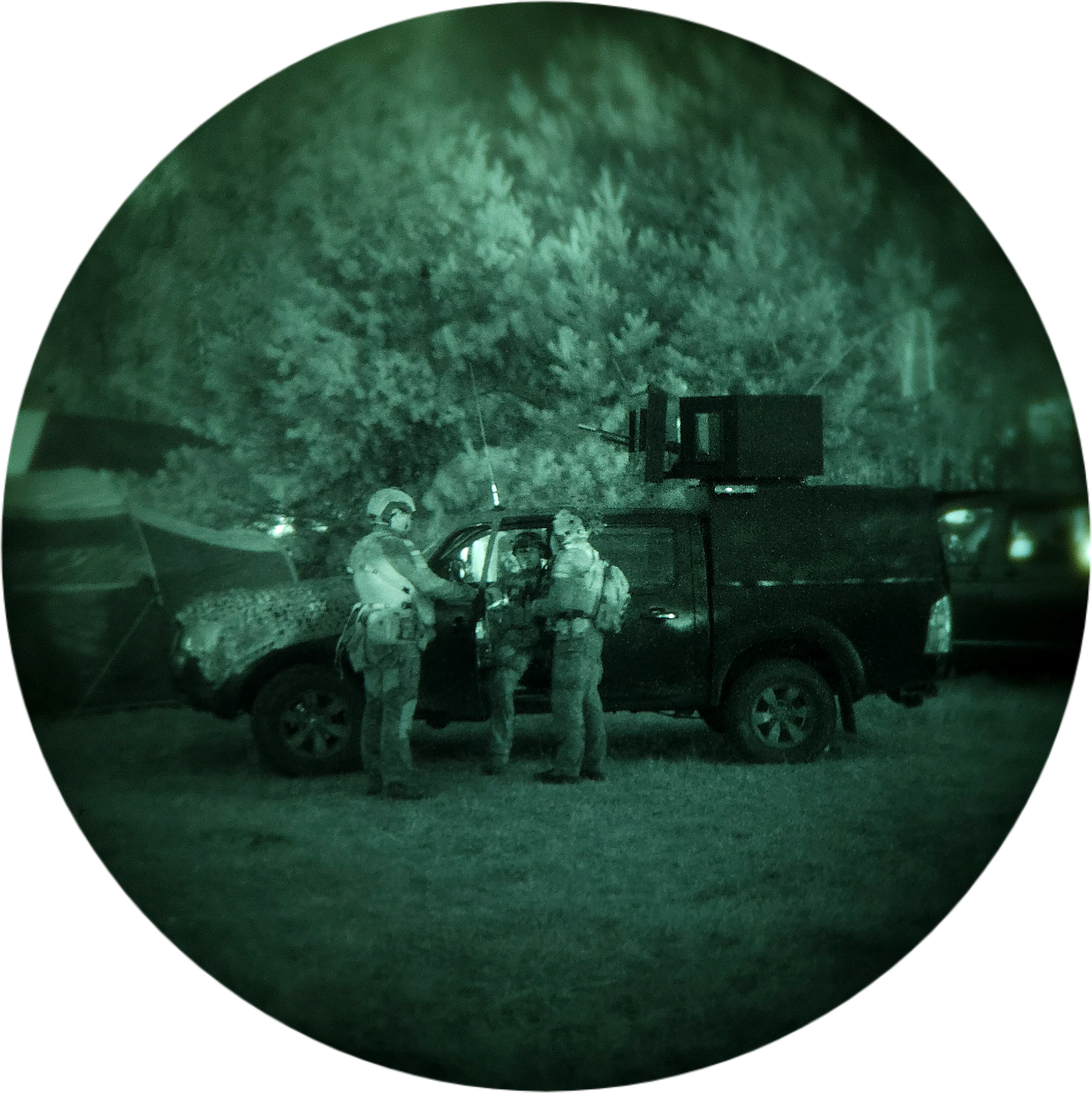 Team in rented night-vision equipment by a vehicle before tactical training