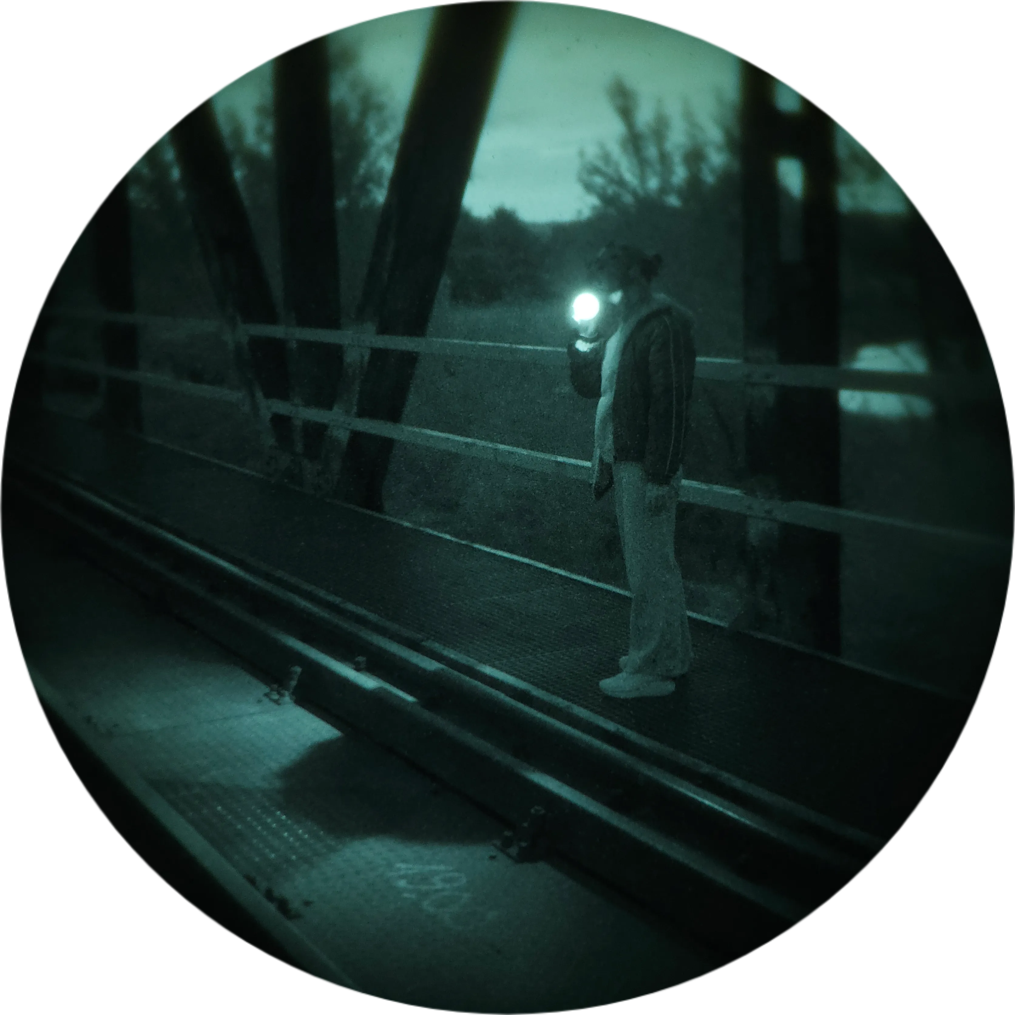 Person with a headlamp on a bridge during a night trip