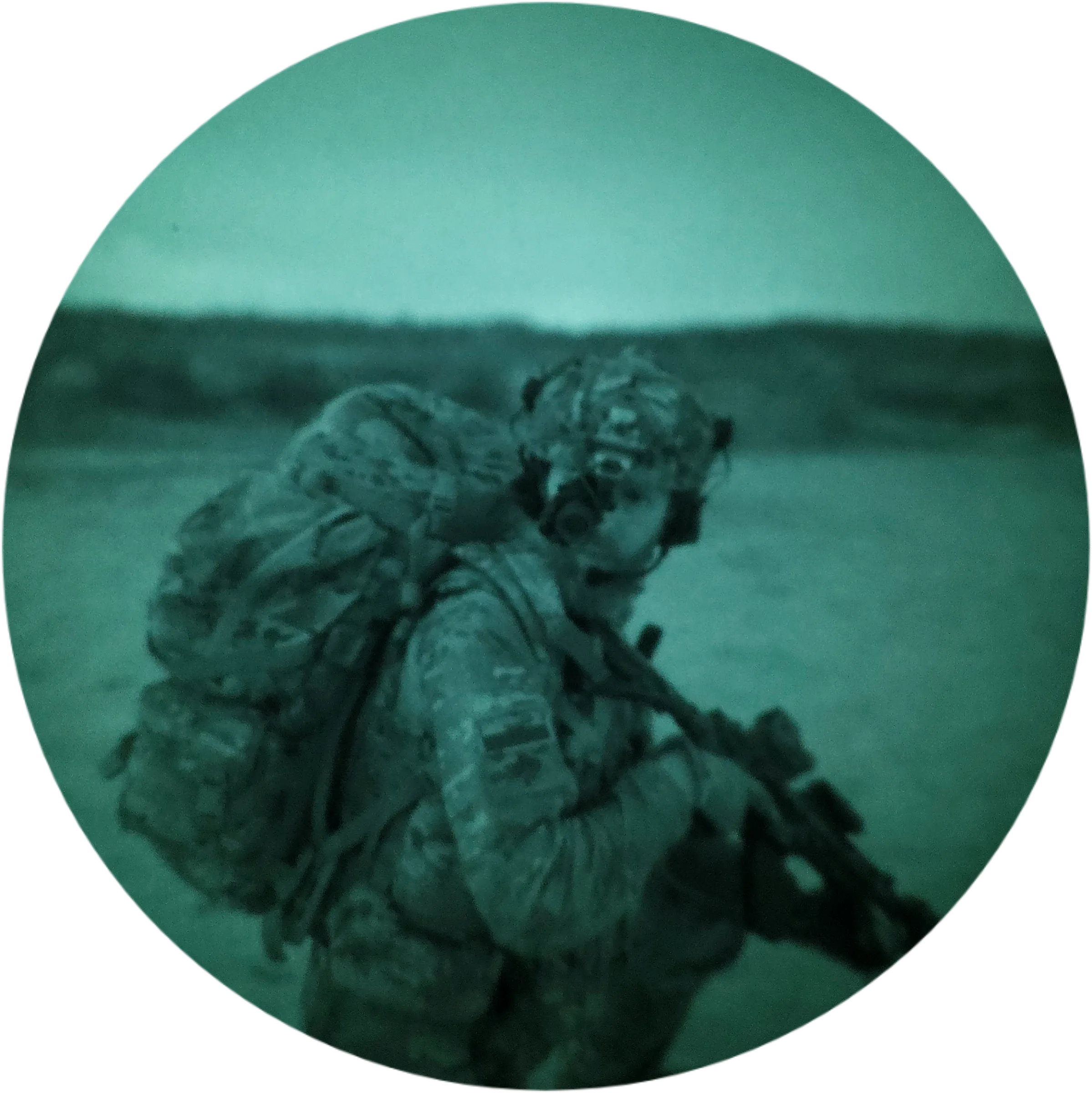 Team member carrying a rented replica weapon and pack across a field, seen in night vision