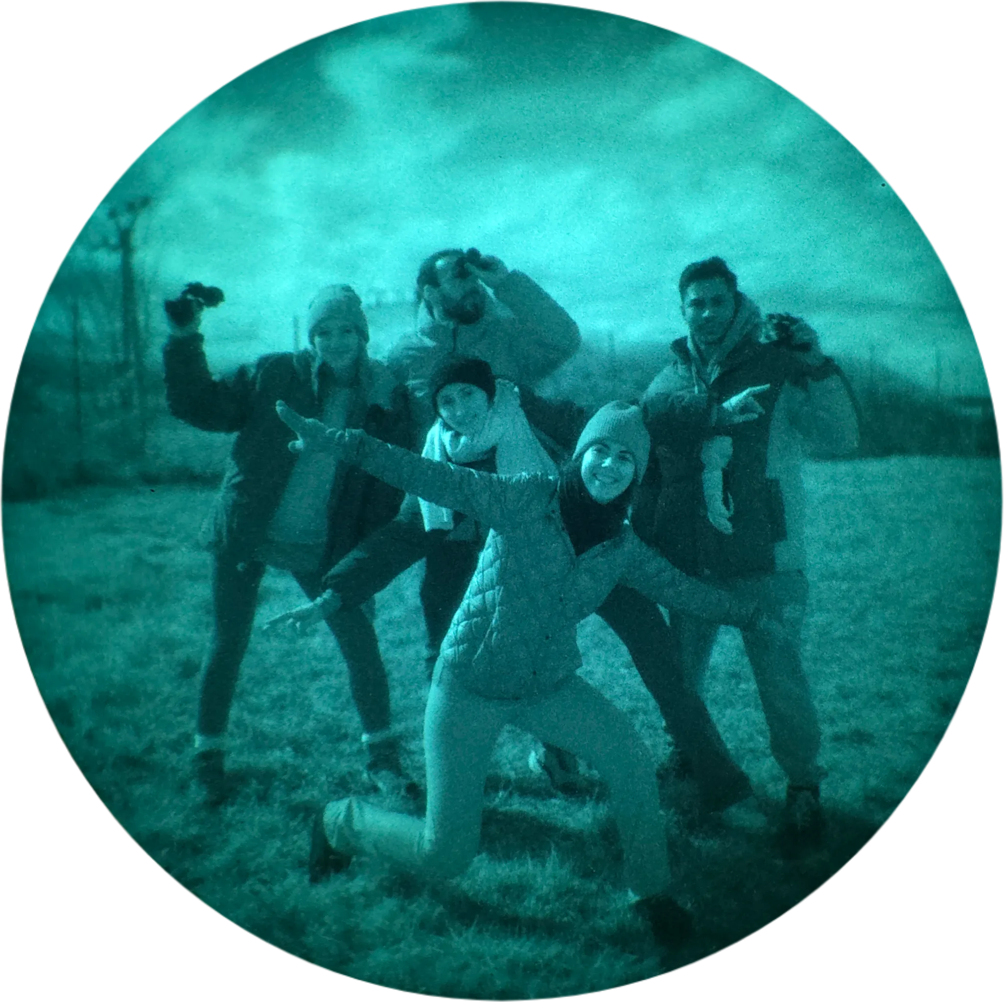 Group of night-trip participants posing in a field, seen in night vision