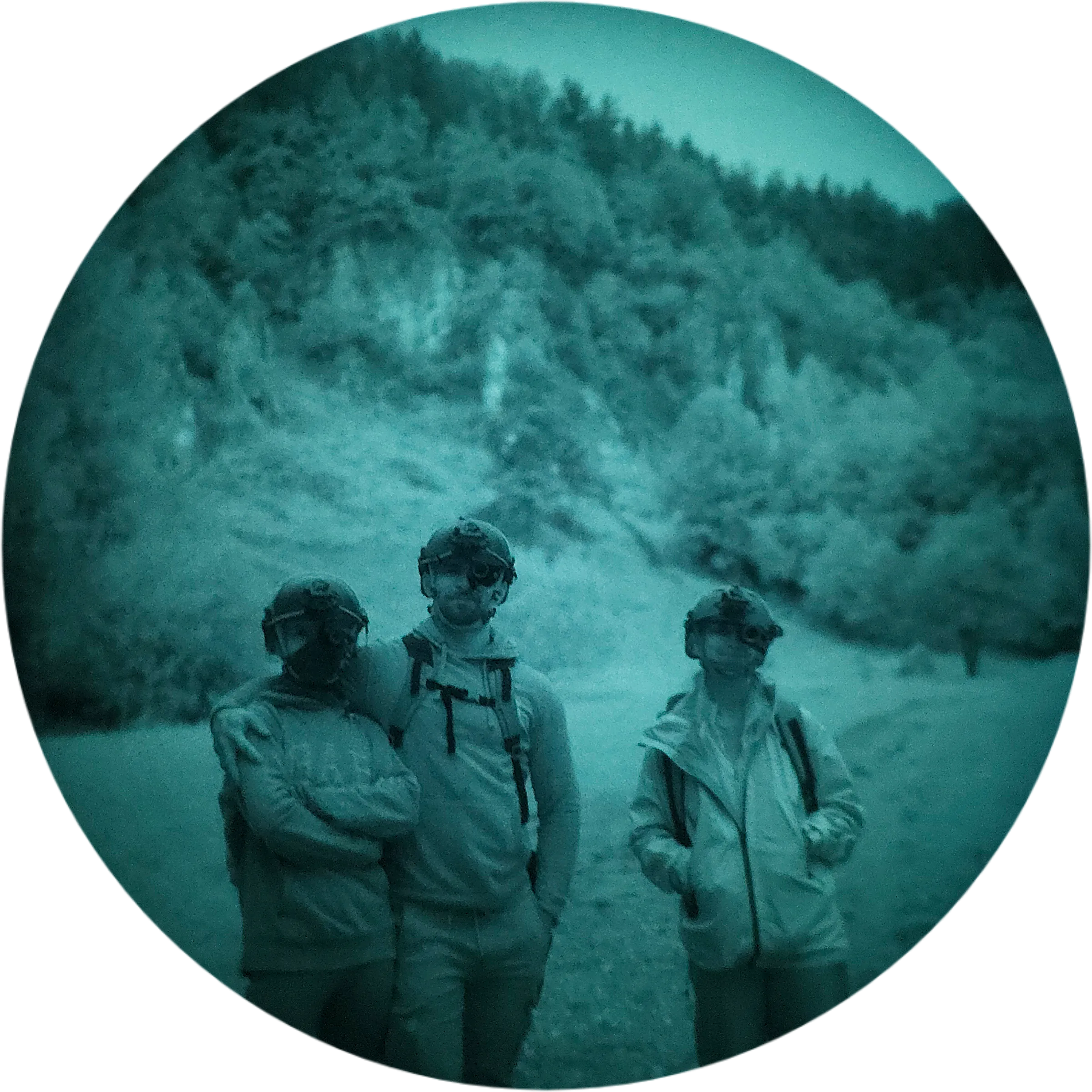 Three trip participants with night vision mounted on their helmets, standing on a snowy trail