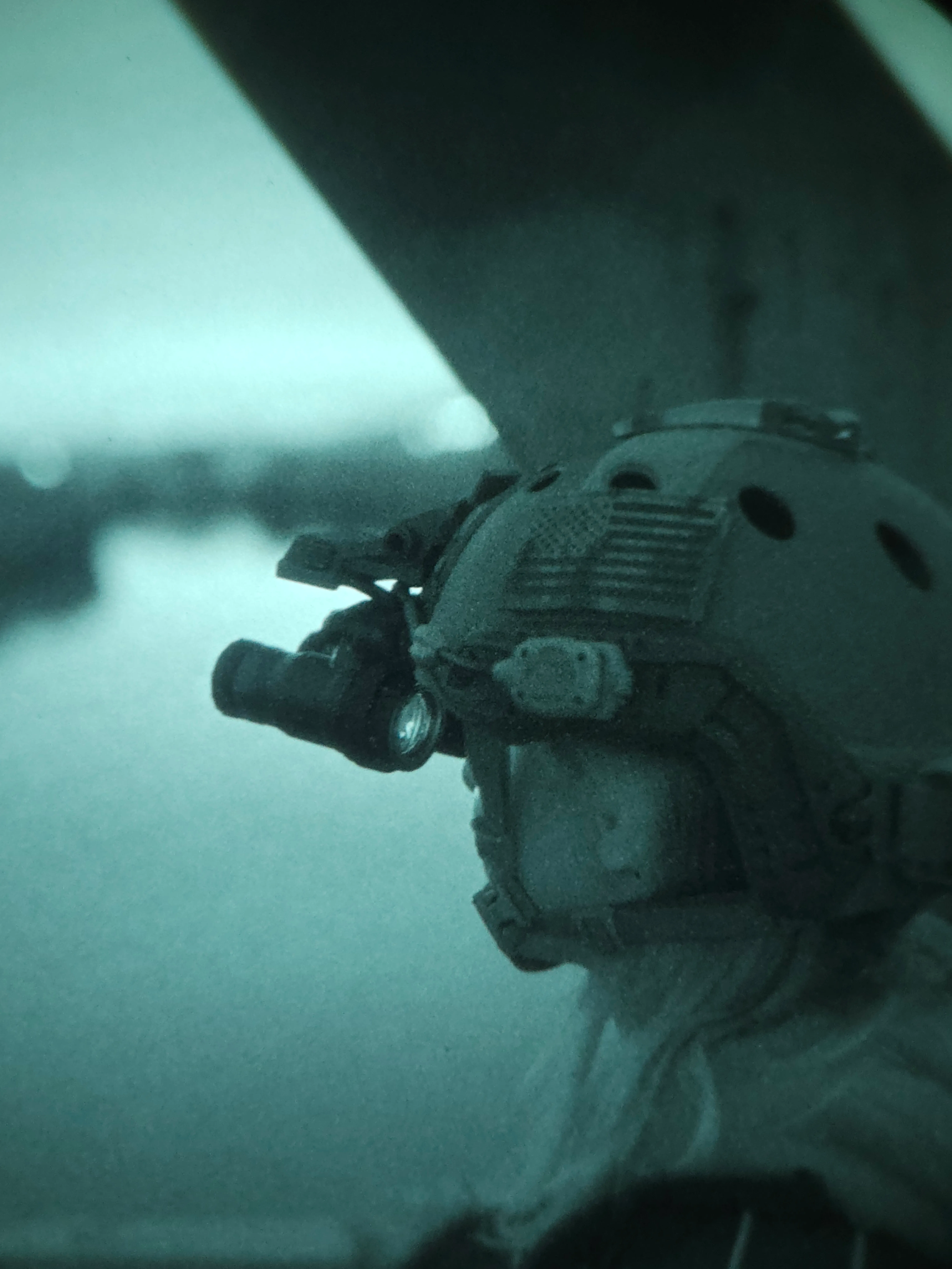Close-up of night-vision goggles mounted on a helmet, daylight photo