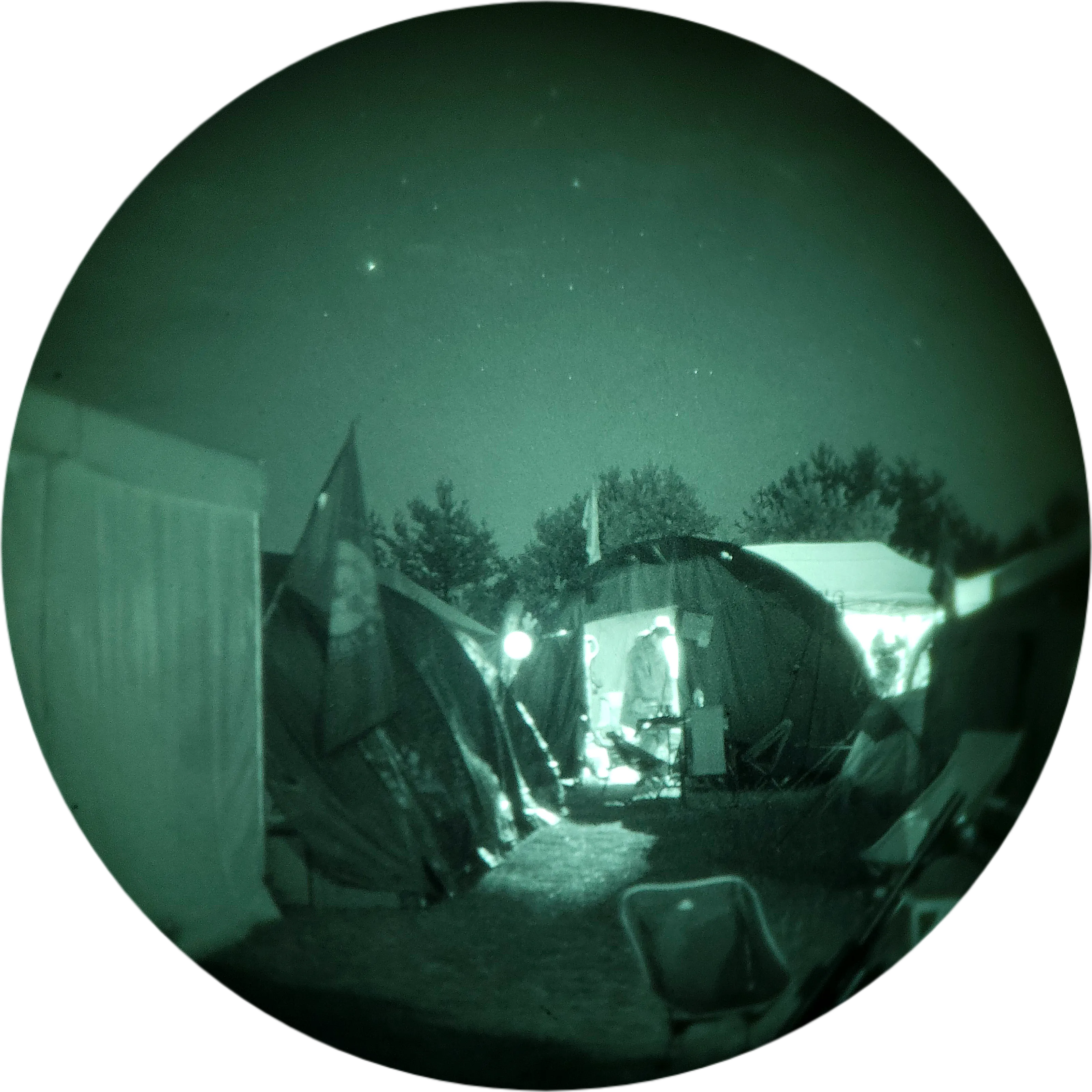 Close-up of a replica weapon with a suppressor and rented night-vision gear on grass