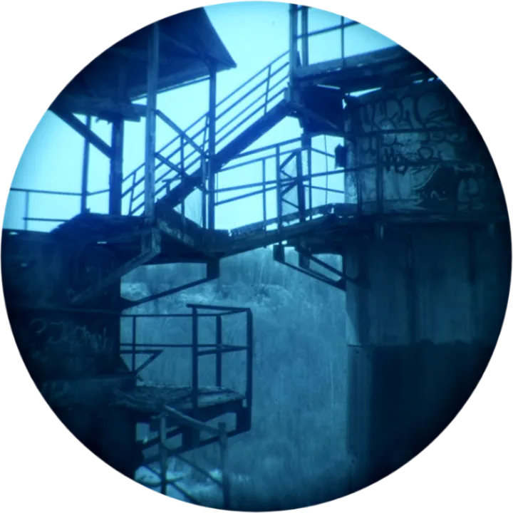 Stairs in an abandoned industrial building, seen through night-vision goggles