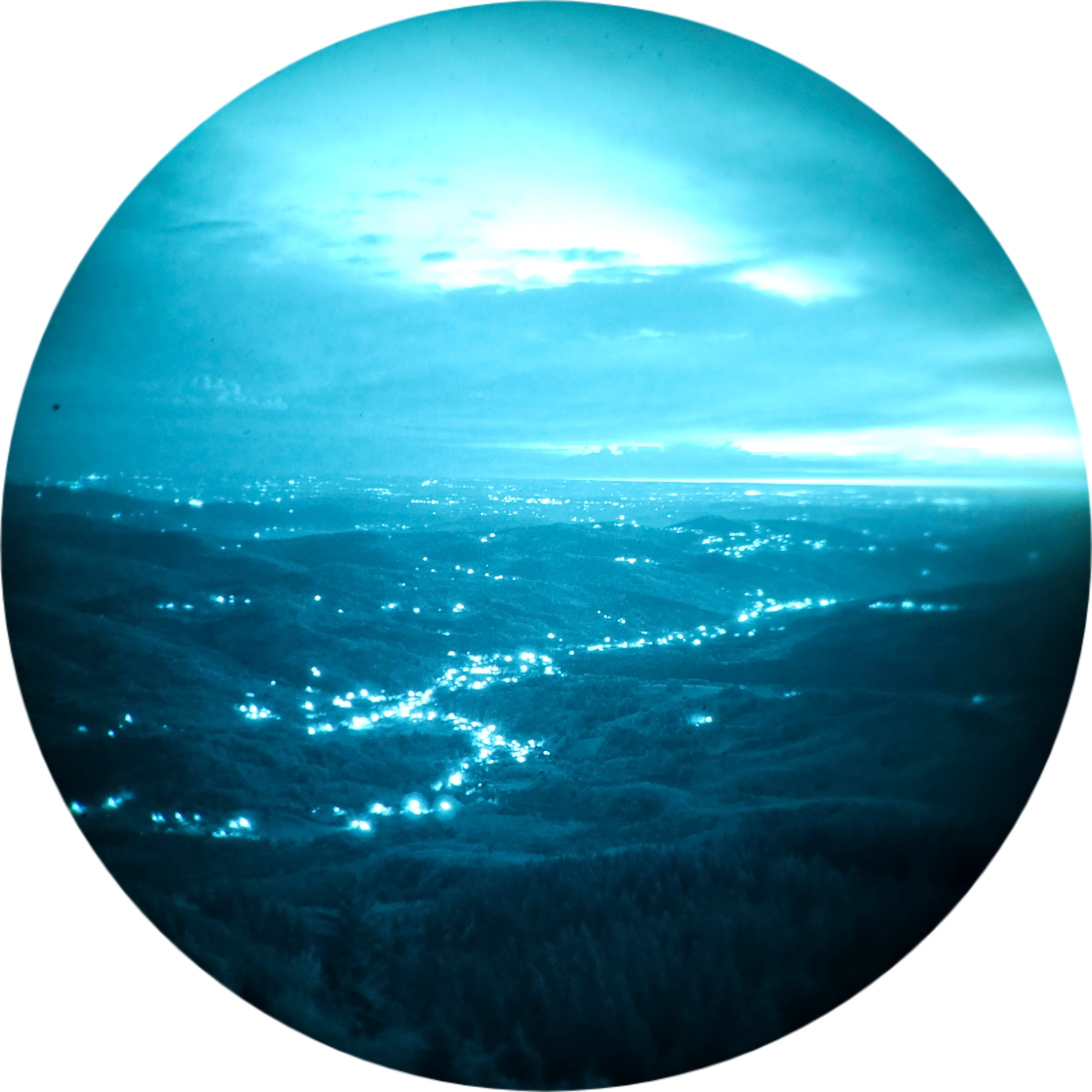 Night view of a valley lit by distant lights