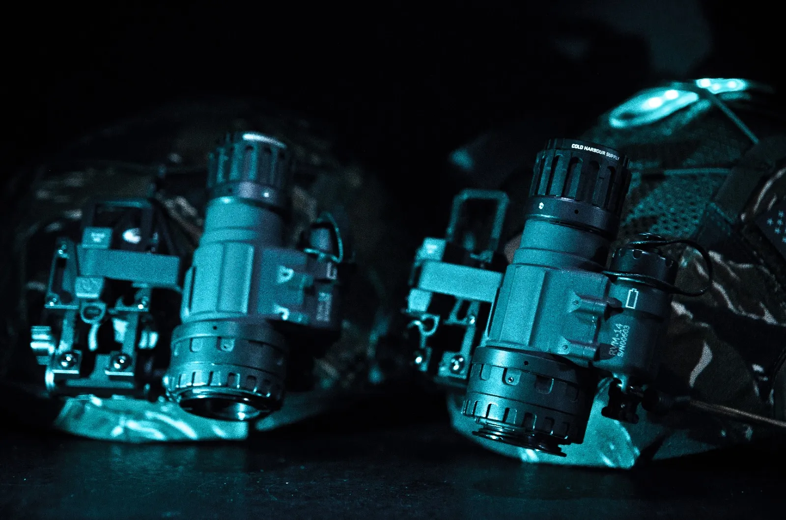 Two night-vision monoculars mounted on helmets, ready for rental
